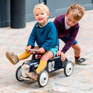 Enfants jouant avec un porteur Roadster bleu nuit Baghera
